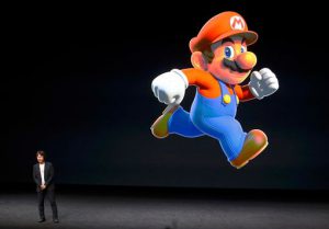 Shigeru-Miyamoto-stands-next-to-the-Super-Mario-character-during-an-Apple-media-event-in-San-Francis